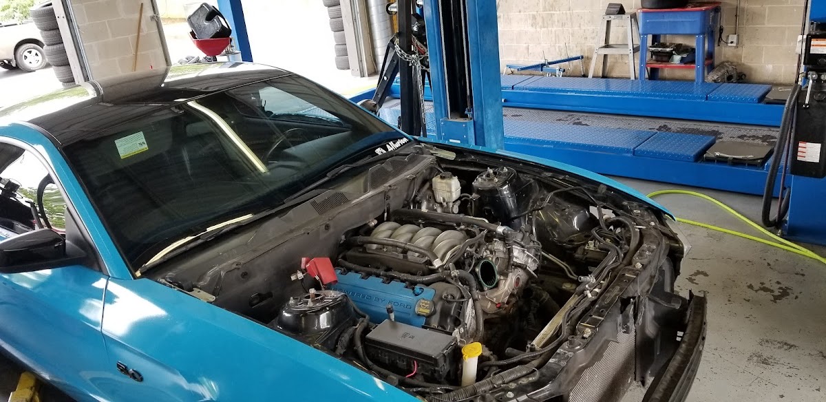 An engine bay open for service in the bay at Liberty Auto